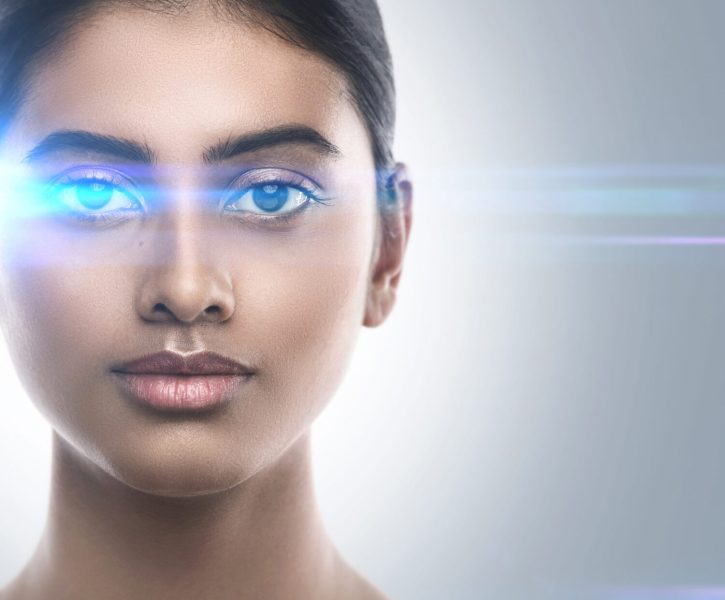 Indian woman in light of optical flares. Concepts of laser eye surgery or visual acuity check-up